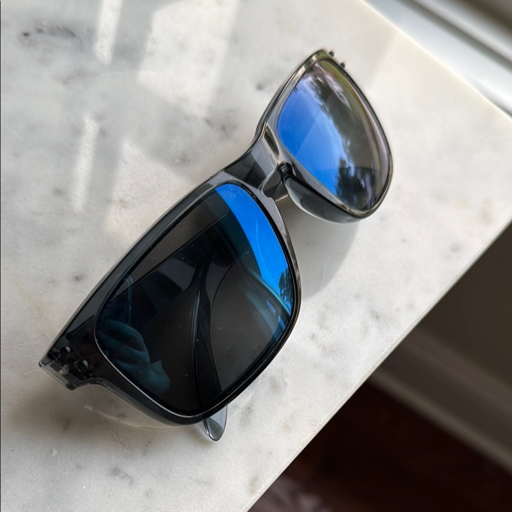 Oakley Holbrook Steel collection. Clear blue smoke frames w. Blue lenses.